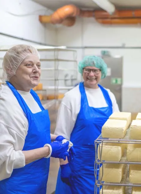 Mitarbeitende der Rohmilchkäserei Backensholz im Produktionsraum.